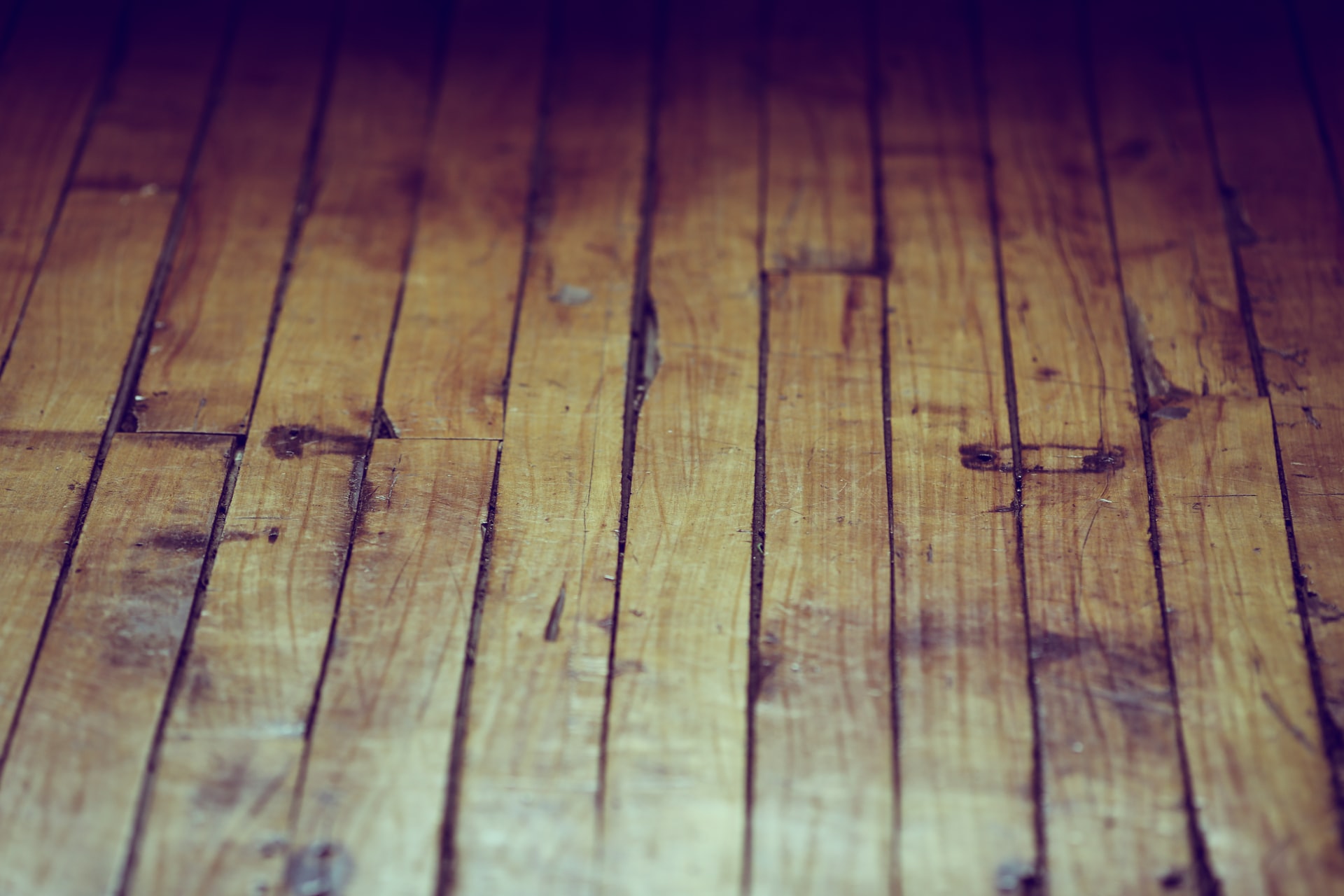 Aged hardwood floor. Photo by Francisco Galarza from Unsplash.