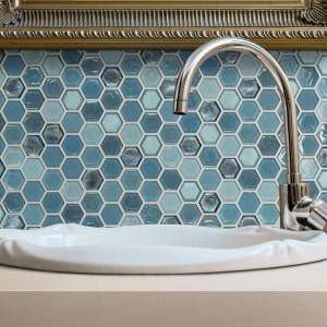 Bathroom scene with Molten Hexagon Glass tile by Shaw, in Santorini