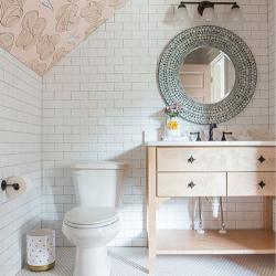 Bathroom renovation with white rectangular tile on walls and hexagonal on floor, and mural on angled ceiling