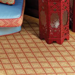 Room scene with custom sisal area rug in natural gold with red diamond pattern woven in