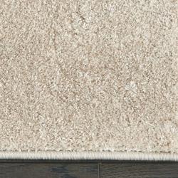 Custom-bound beige area rug with modern edge