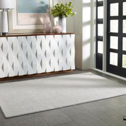 Hallway scene with custom-bound pale grey area rug
