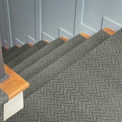 Stairs with grey carpet runner with subtle herringbone pattern