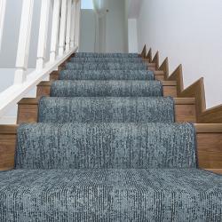 Stairs with textured carpet runner in linear blue pattern