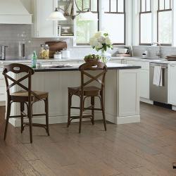 Kitchen renovation with brown hardwood floors, off-white cabinets and pale grey tile backsplash