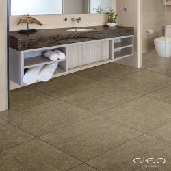 Bathroom scene with polished stone countertop and warm brown  limestone composite flooring