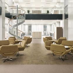Office scene with two different types of earth-toned luxury vinyl flooring