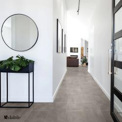 Hallway scene with large rectangular taupe tile floor